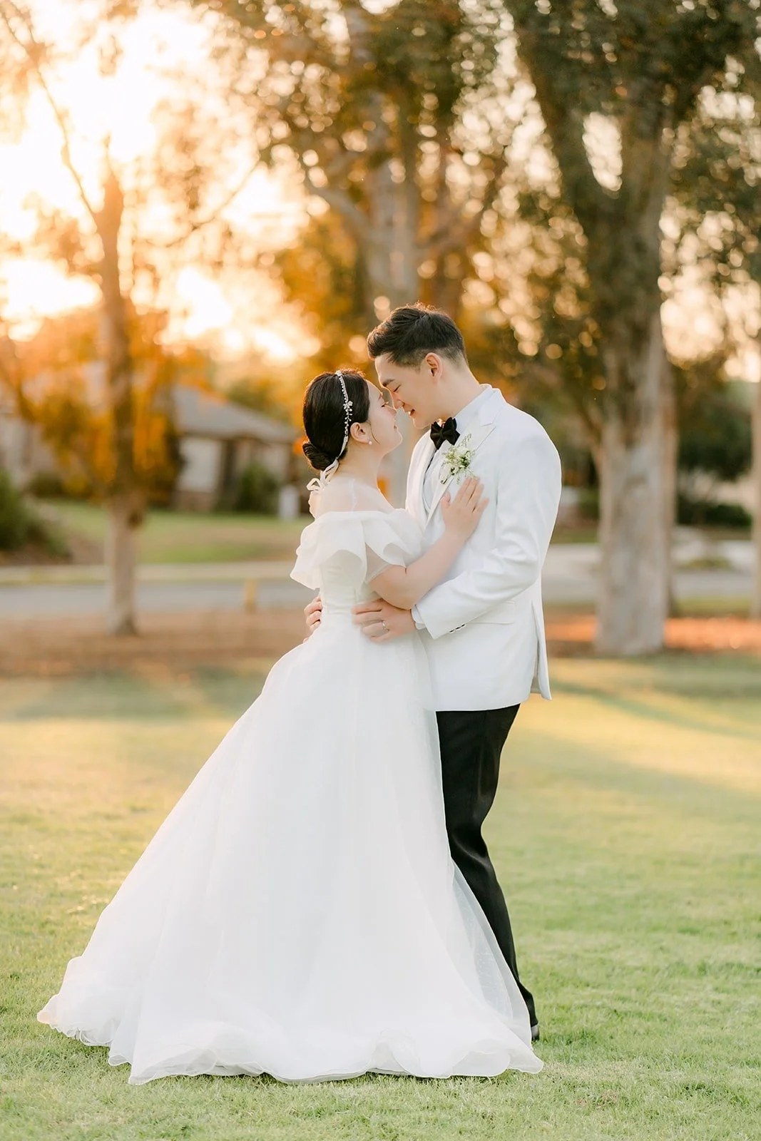 Amy and Sam in their second looks at golden hour on the lawn