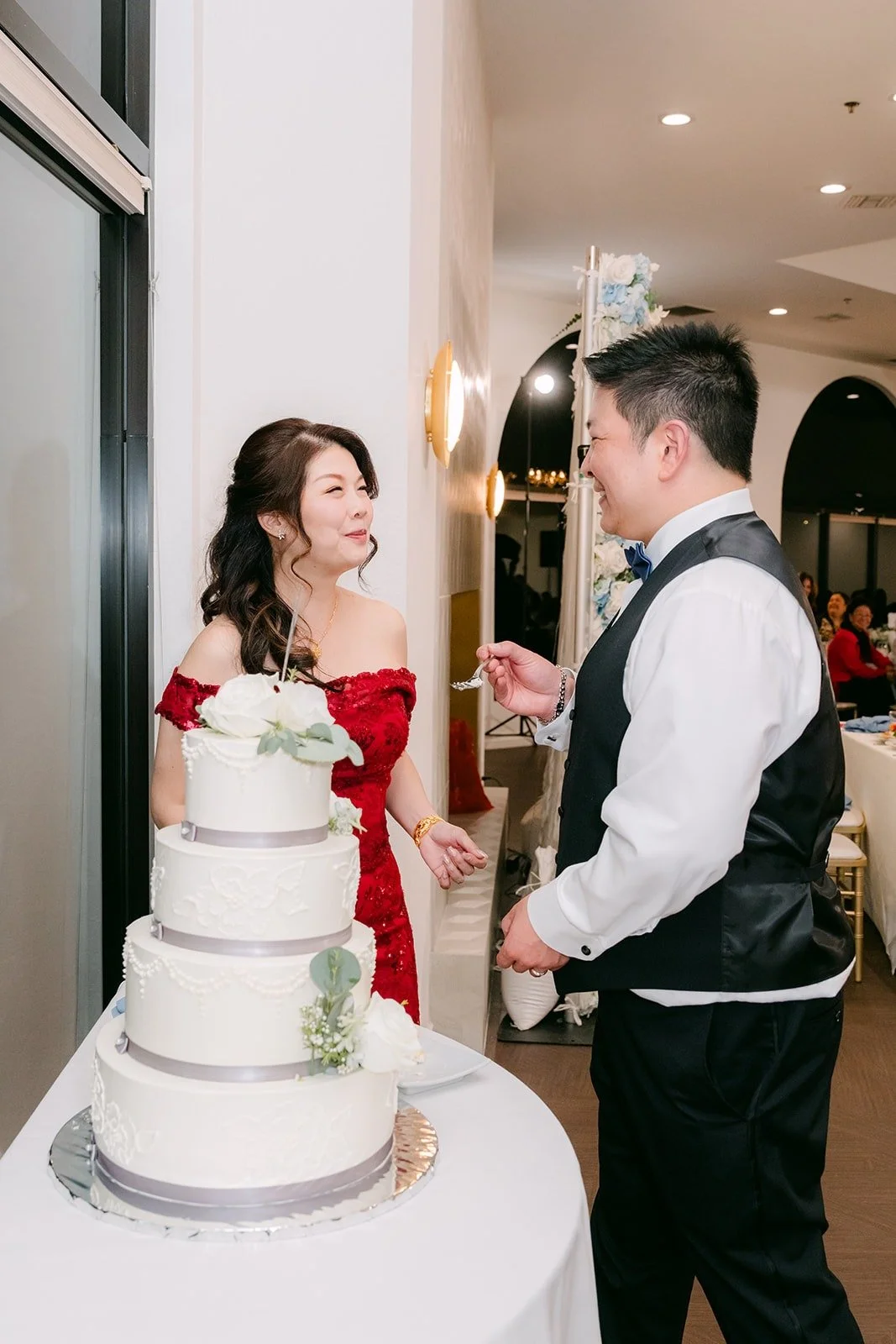 Sochi and Jay smile beside the cake after the cut