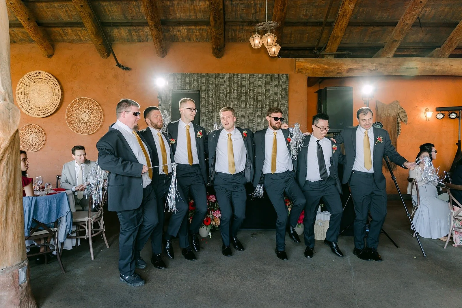 The groomsmen dancing in a line during the grand entrance