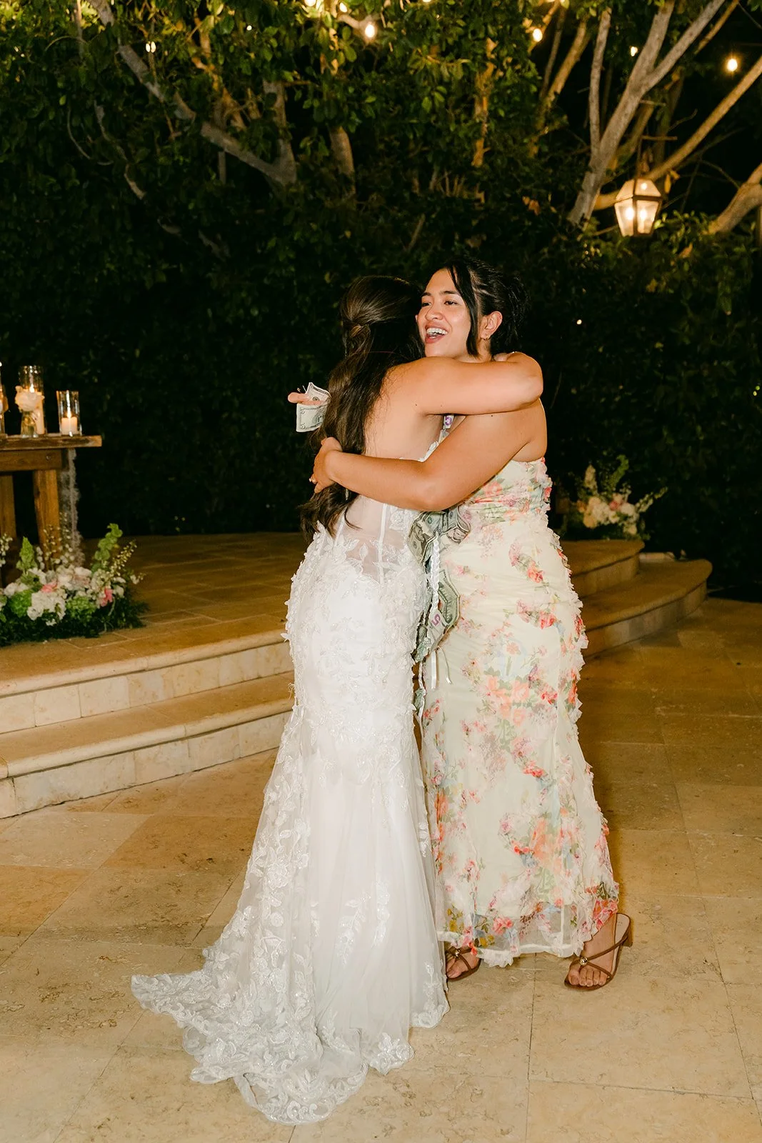 Nicole hugging a guest during the money dance.