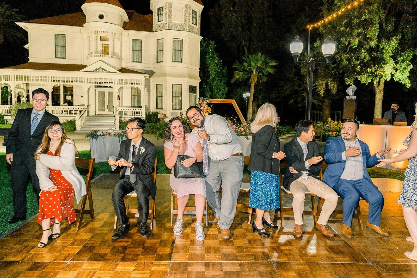 Guests laughing during the reception games, photographed by One and Only Production