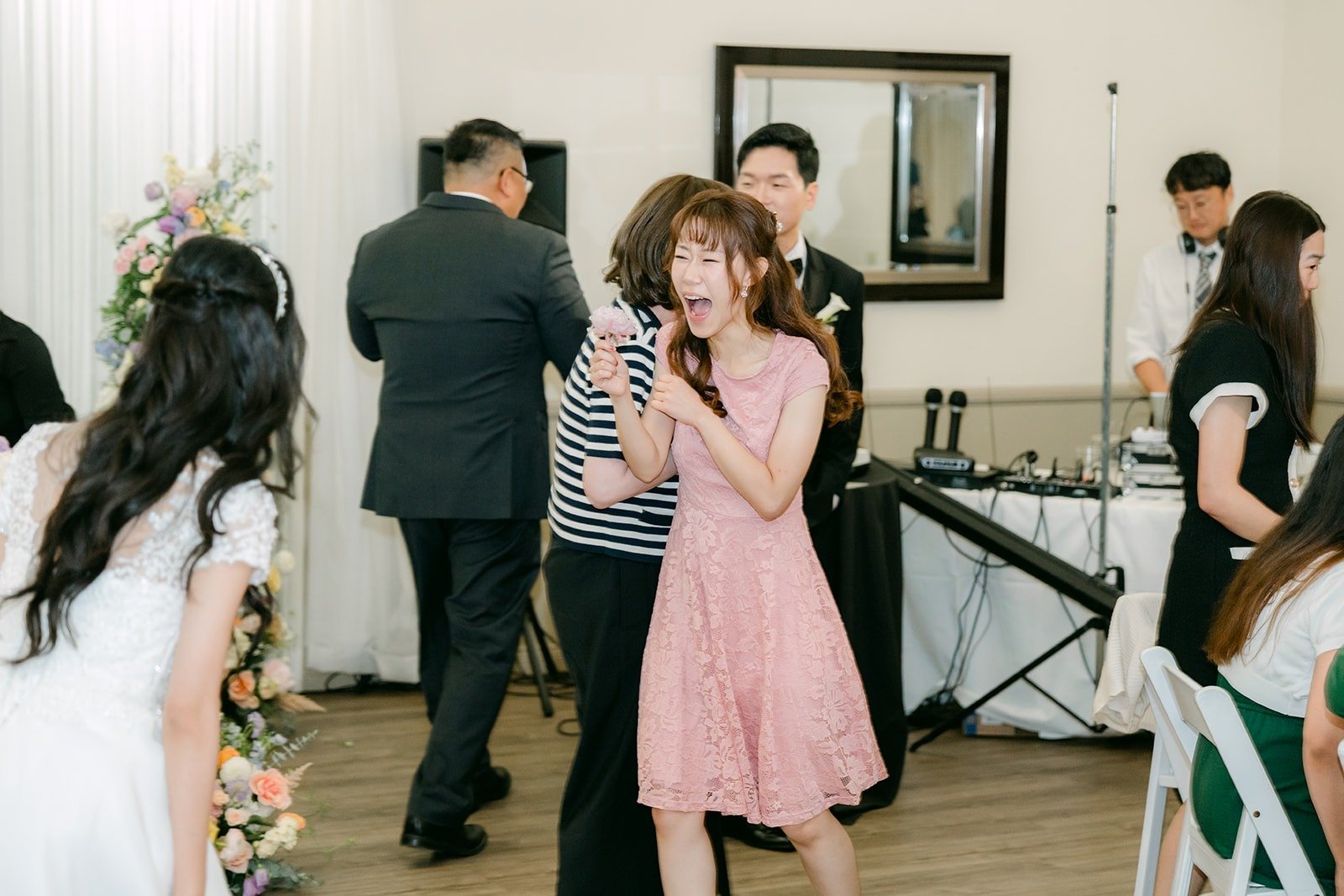 A guest celebrating after catching the bouquet