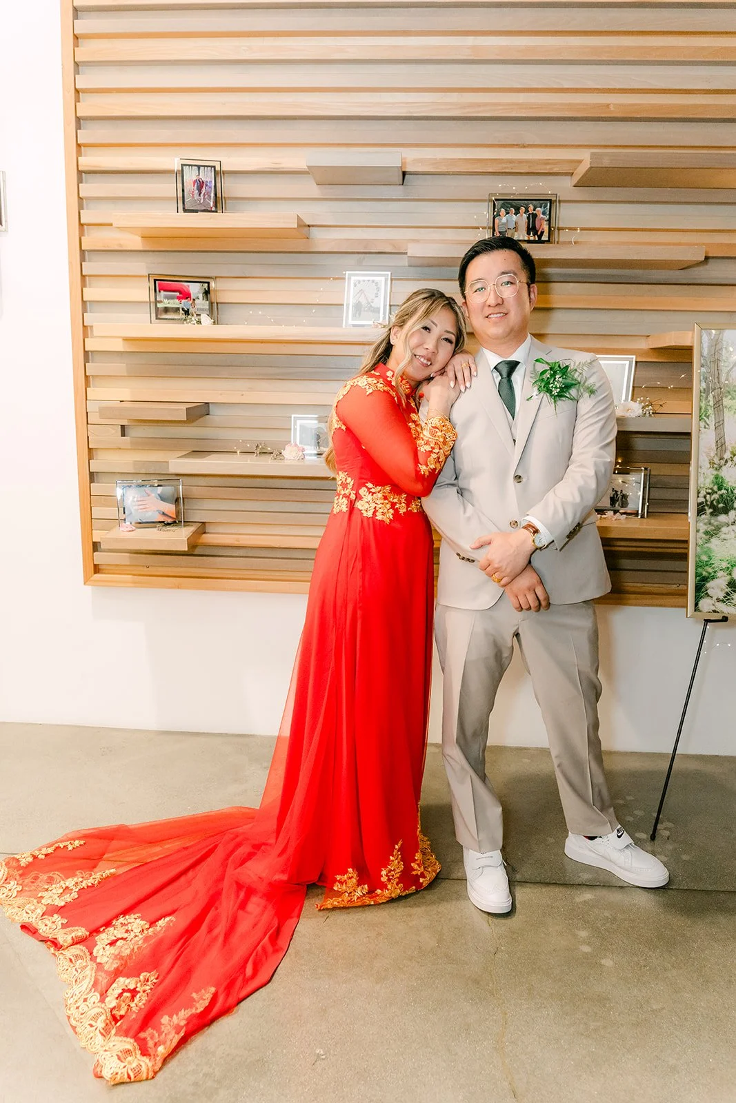 Raine in a red and gold traditional dress with Ricky