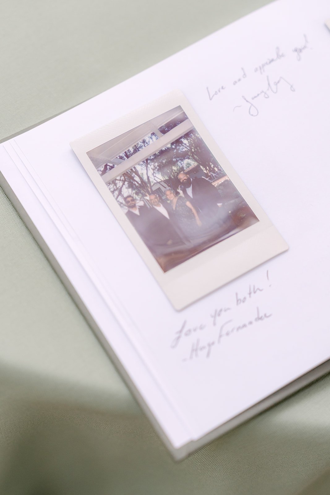 A Polaroid tucked into the guest book with a handwritten note