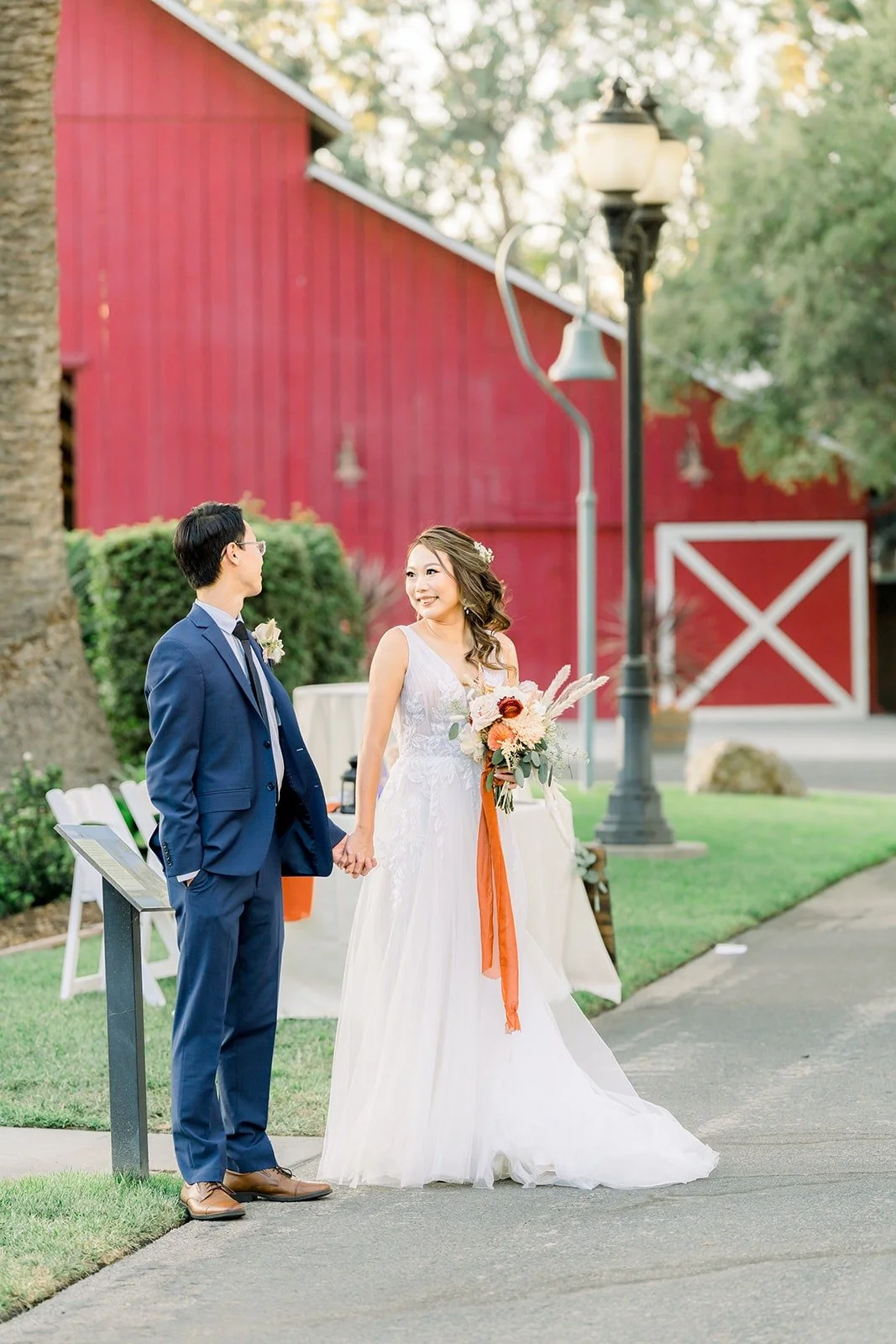 Ariel and Alex beside the red barn
