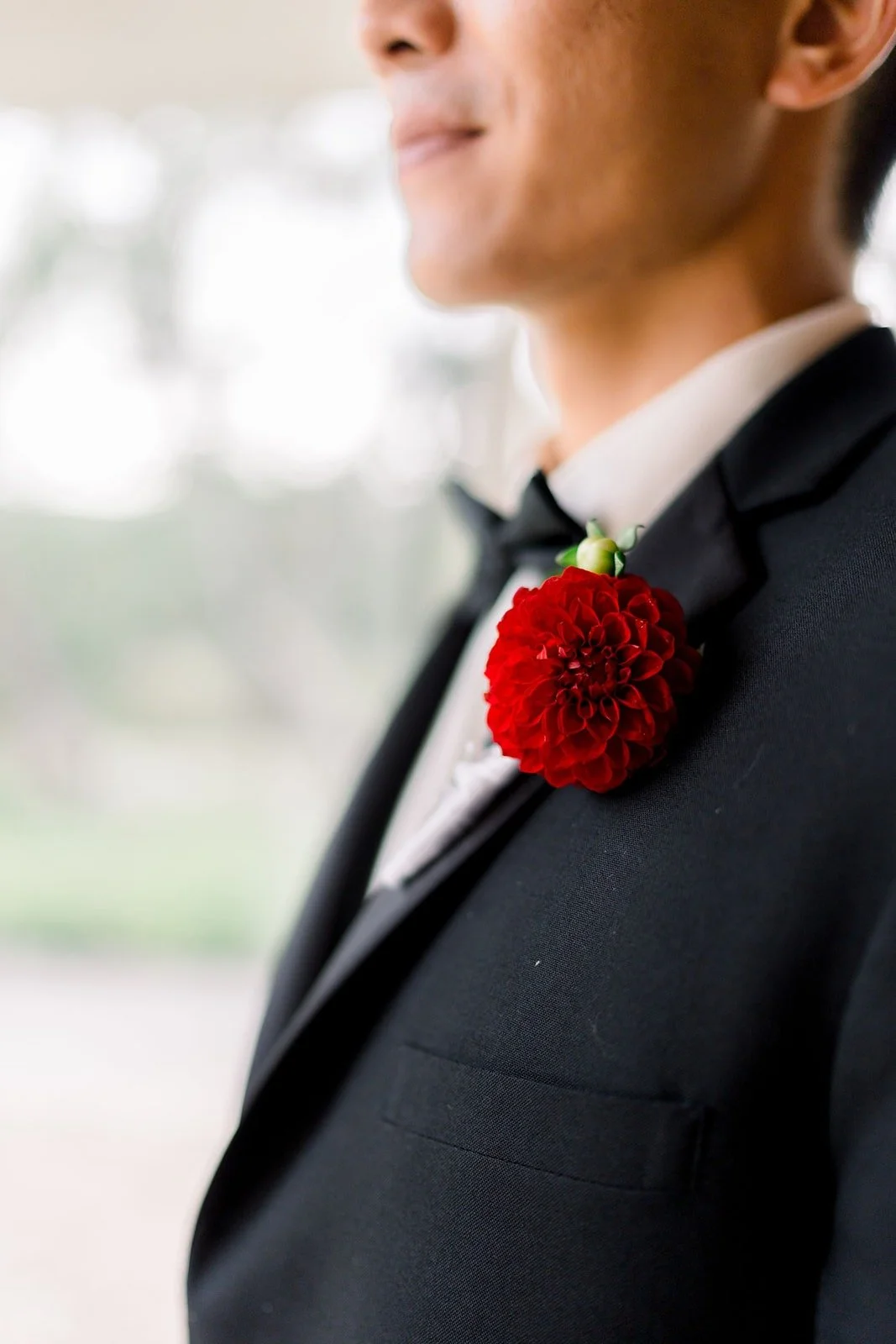 Close up of Steven's red rose boutonniere