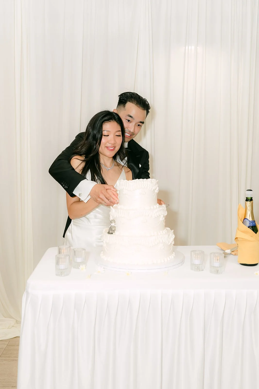 Kim and Vincent cutting their cake from Torrance Bakery