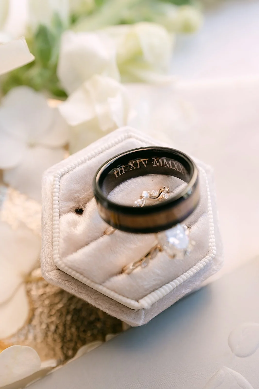 Wedding bands in a white ring box.