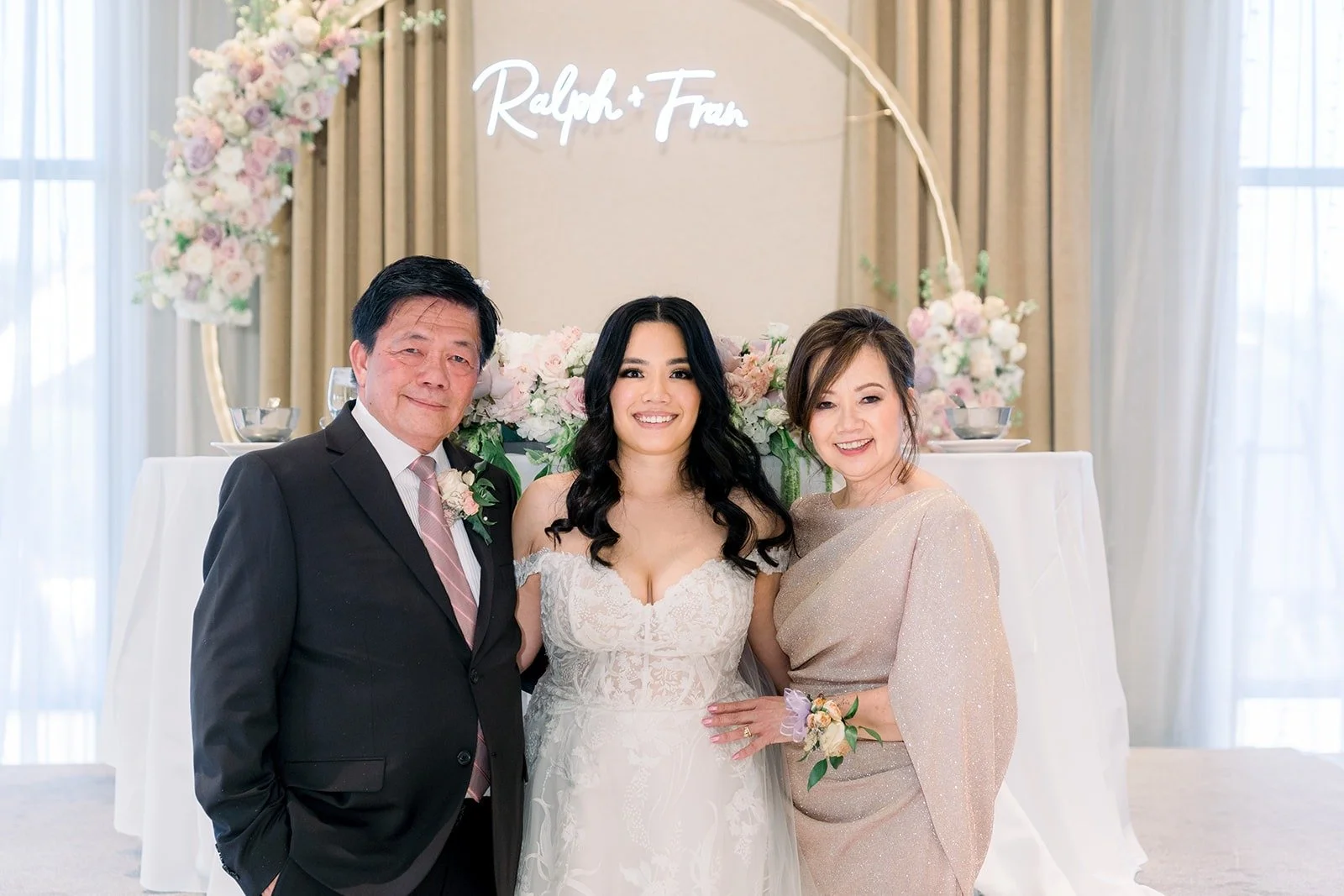 Francesca with family members beside the floral hoop