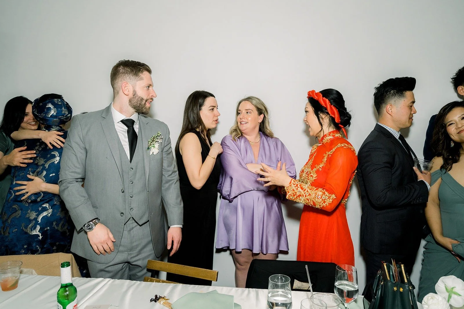 Guests share a toast at their table, photographed by One and Only Production