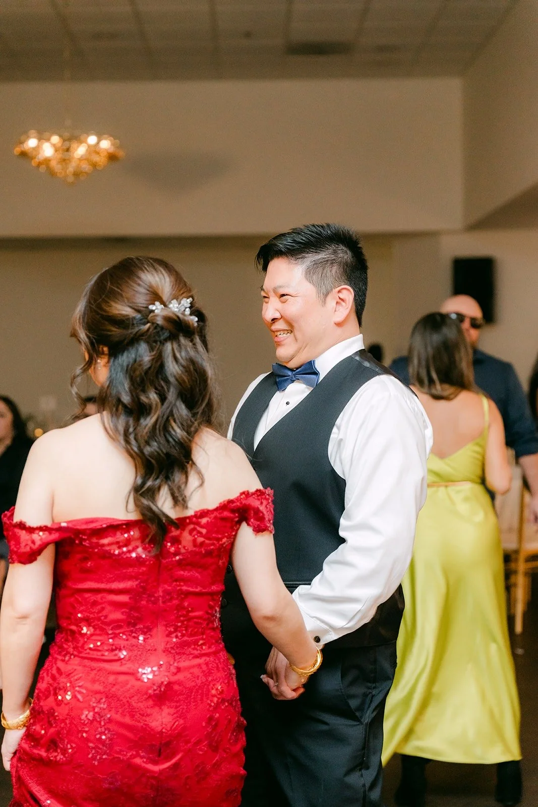 Sochi and Jay dance with friends around them