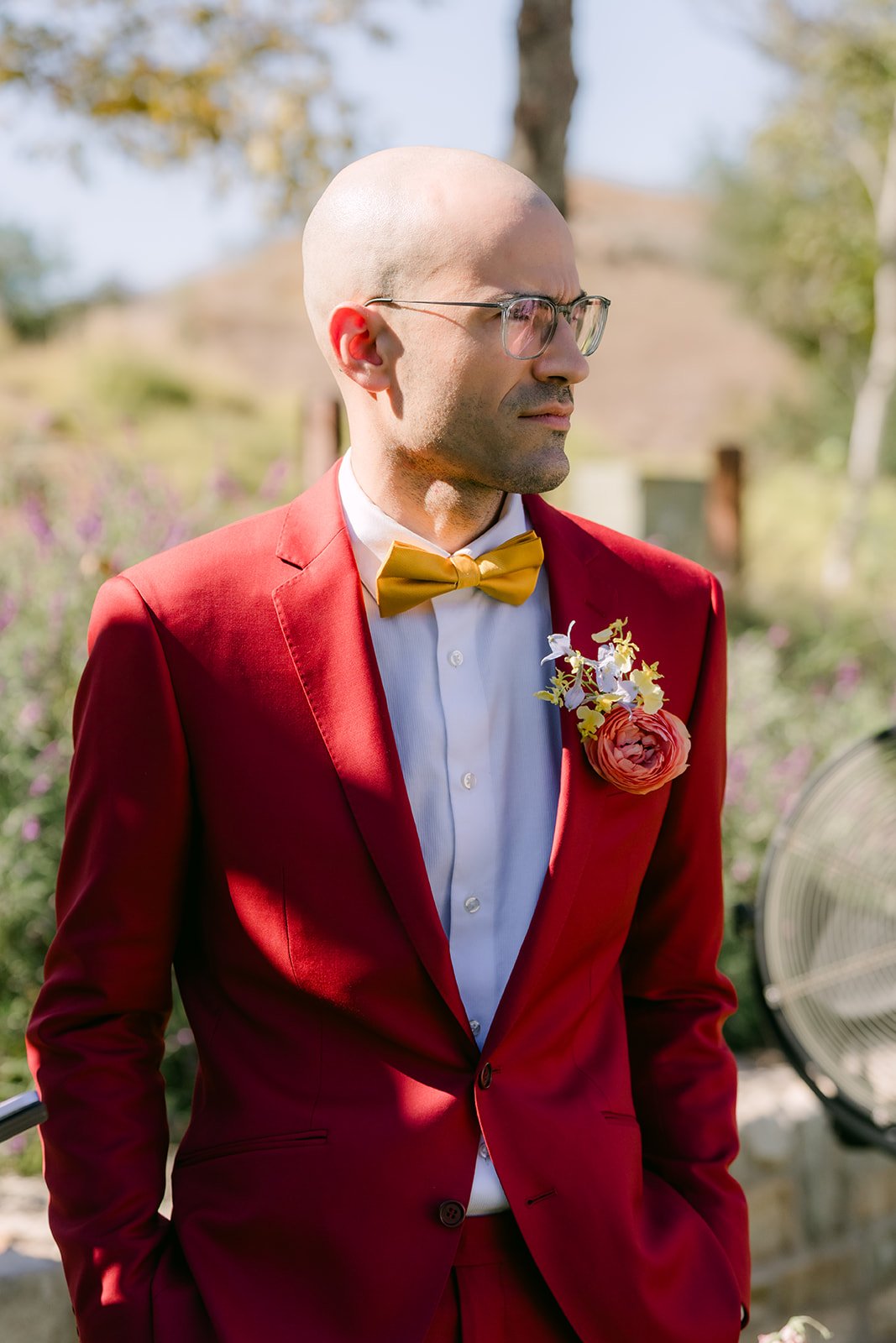 Christian in his red suit and yellow bow tie waiting for the ceremony to begin.