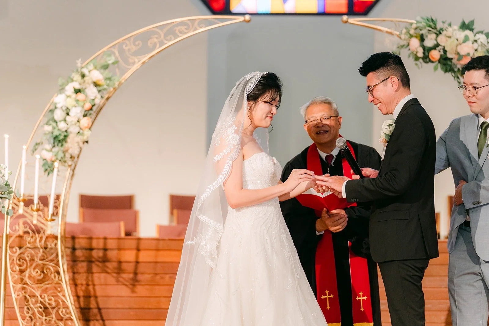 Eunice and Eric say their vows under the gold arch