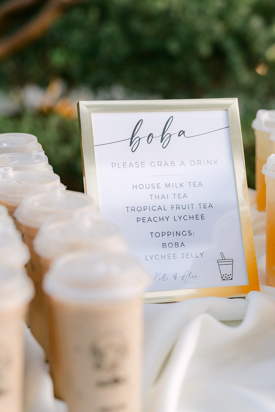 Rows of Azuki Tea boba drinks beside their menu sign