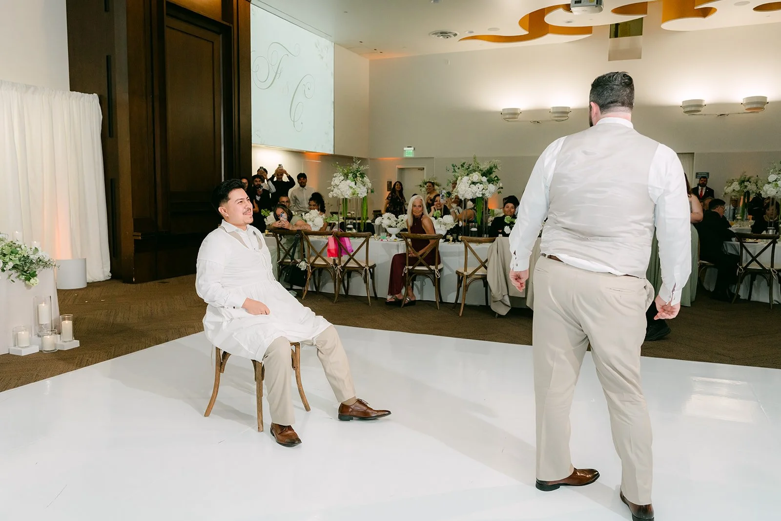 Fernanda seated for the garter toss as Cody looks on.