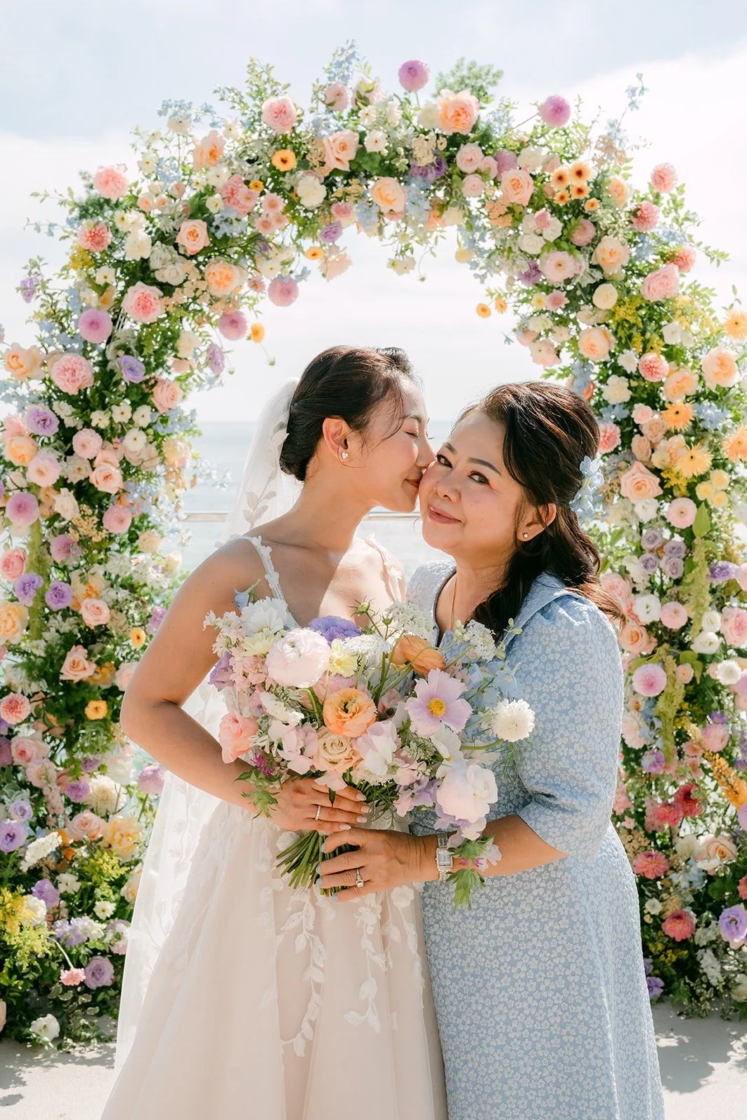 Kylie sharing a hug with a family member under the arch