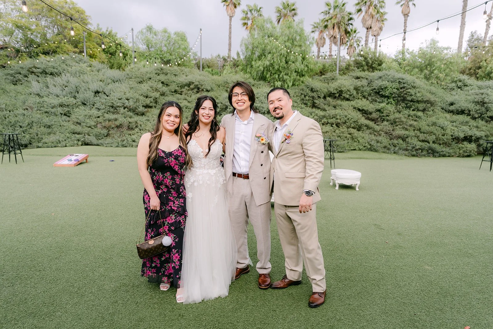 Kat and Mike with guests on the lawn during cocktail hour