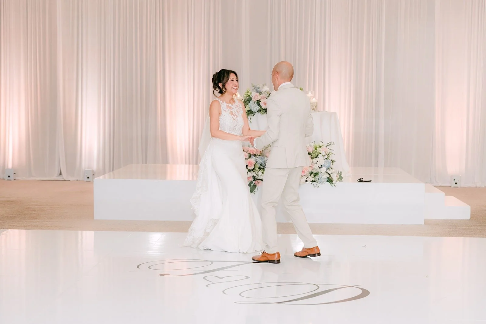 Francesca and Daniel twirl during their first dance in the Carousel Ballroom