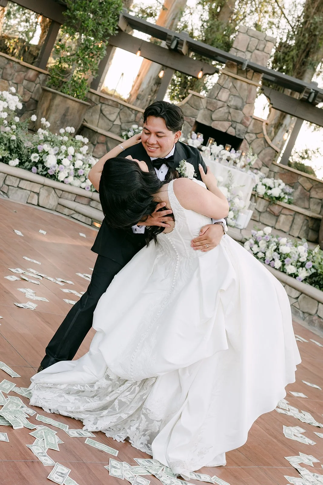 Groom dipping the bride at the end of their first dance