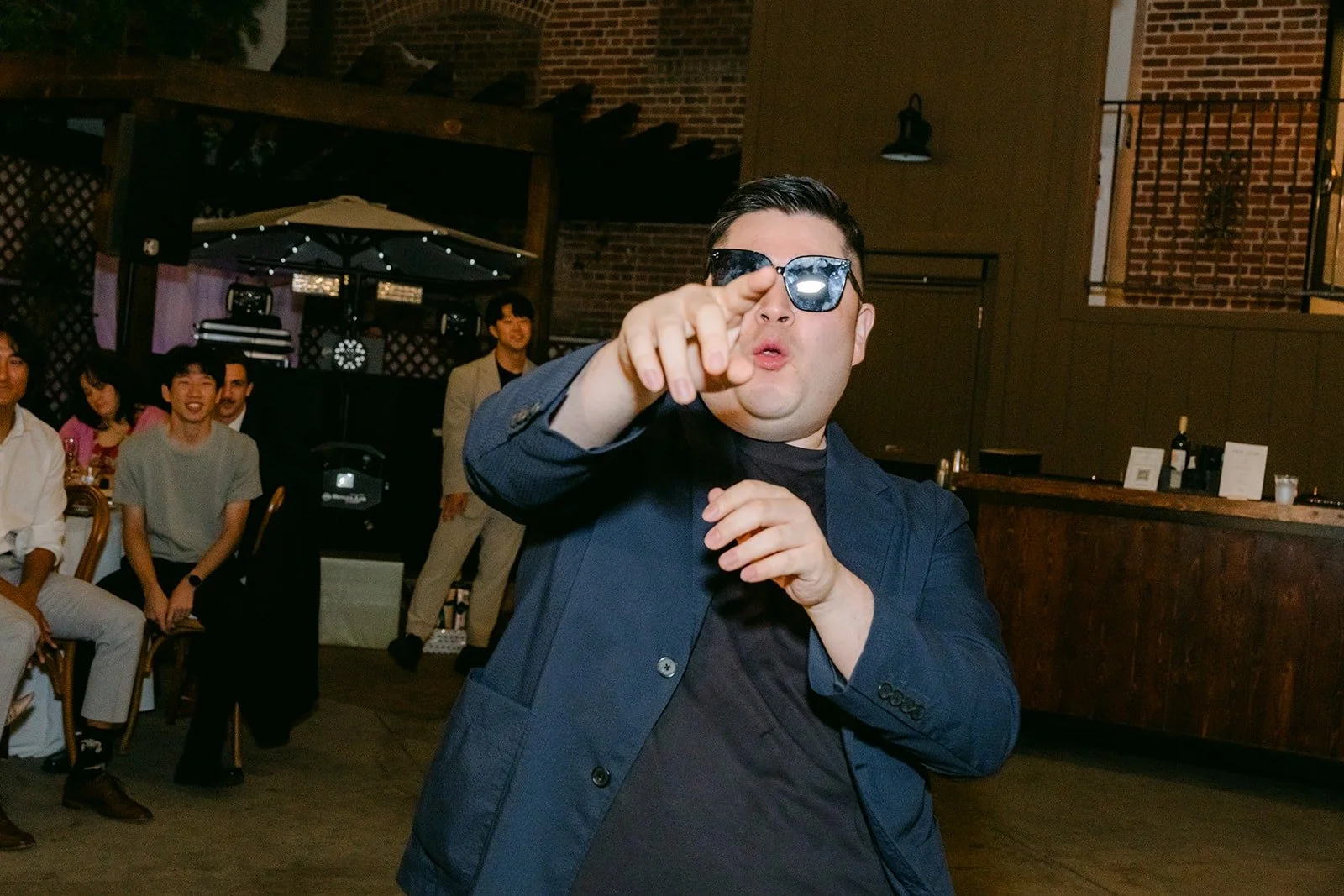 A guest pointing at the camera from the dance floor