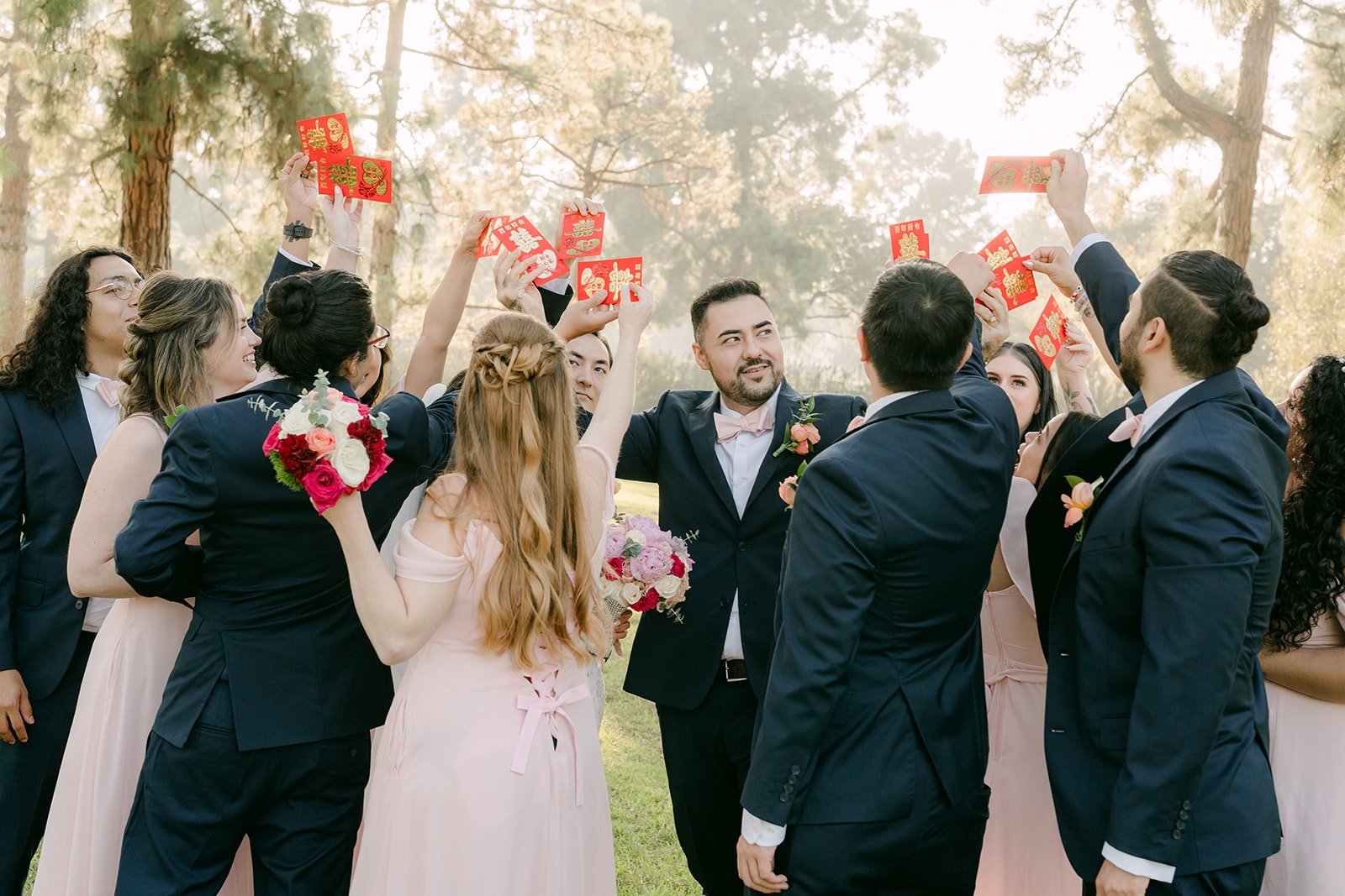 Groomsmen and bridesmaids celebrating around the couple