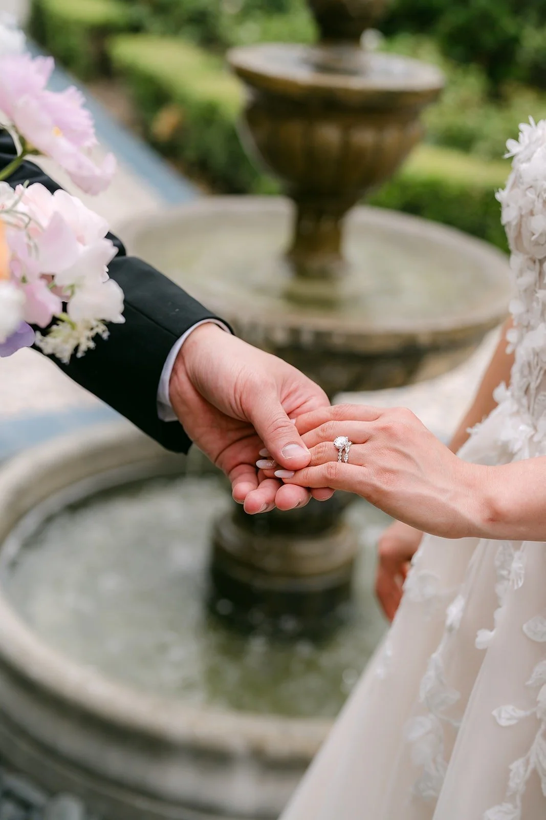 Mario holding Kylie's hand beside the stone fountain