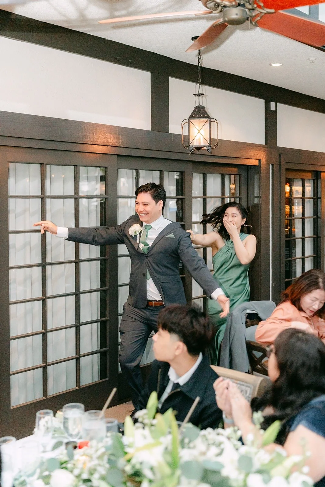 A groomsman showing off his moves during the grand entrance