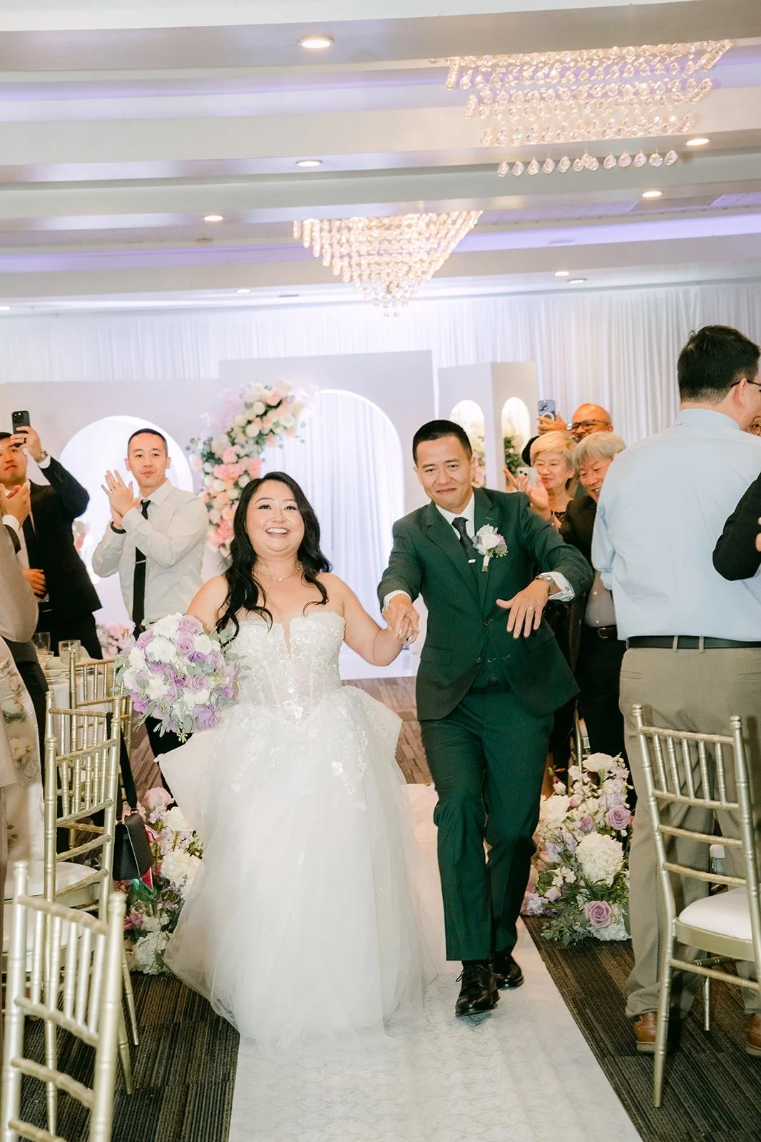 Jennifer and Kevin make their grand entrance through the cheering guests