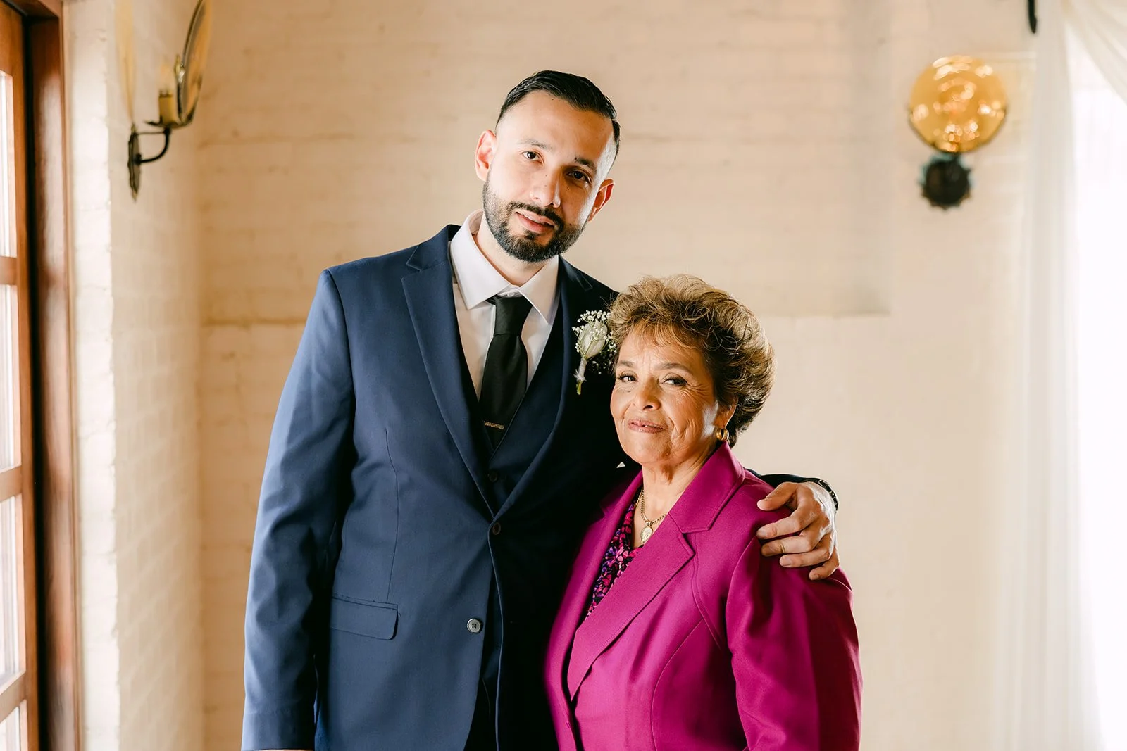 Danny and his mom smiling together in the groom's room