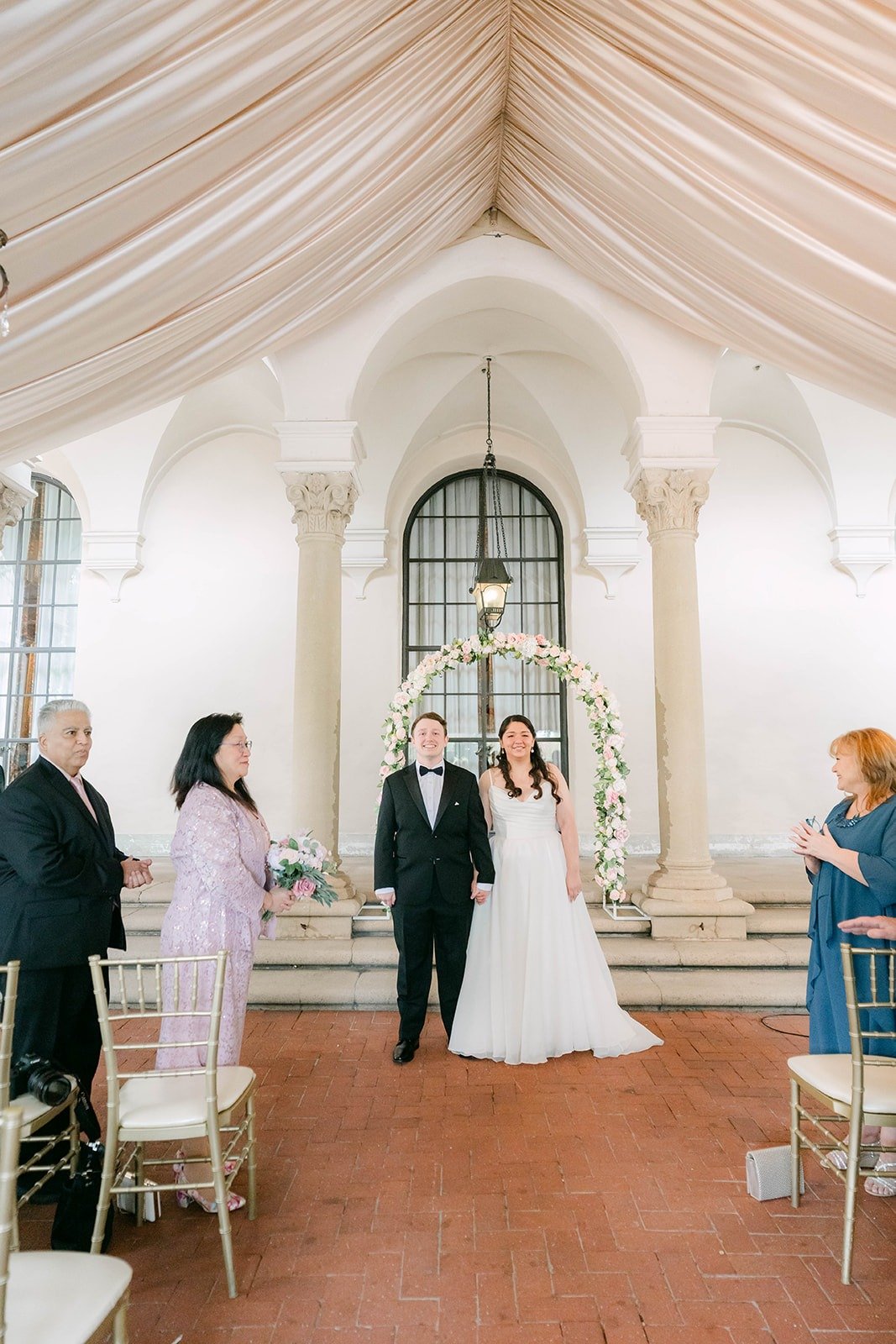 Saira and Matthew walking back up the aisle as a married couple