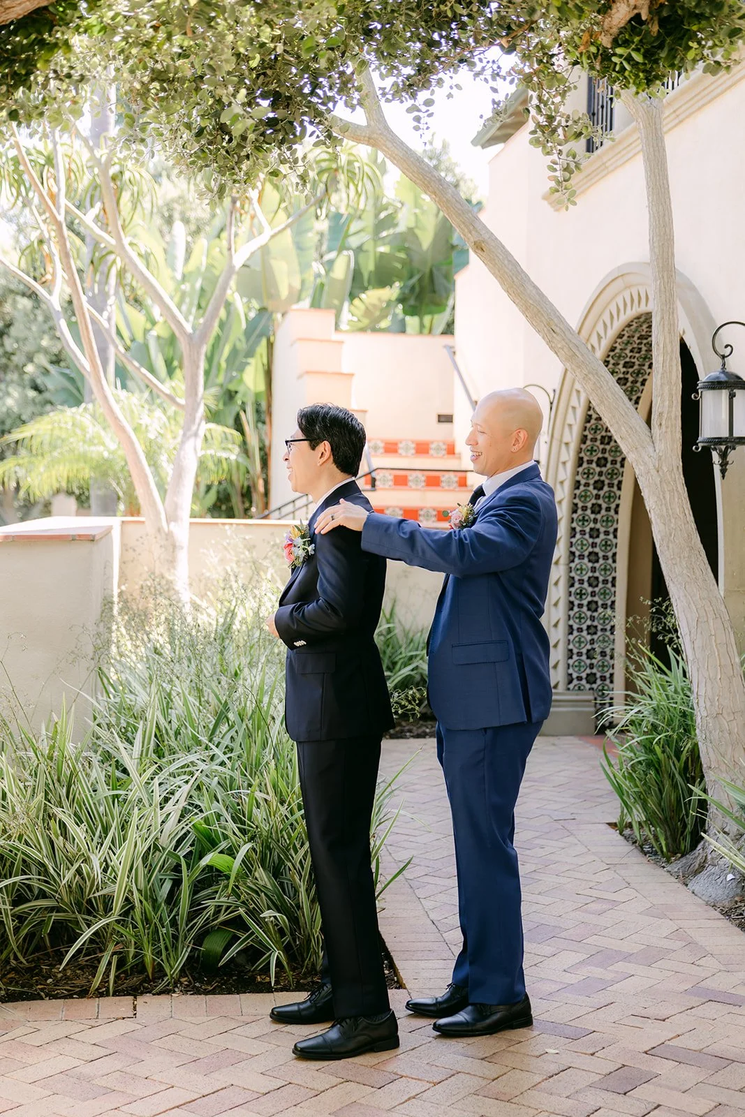 Leroy getting help with his suit in the courtyard
