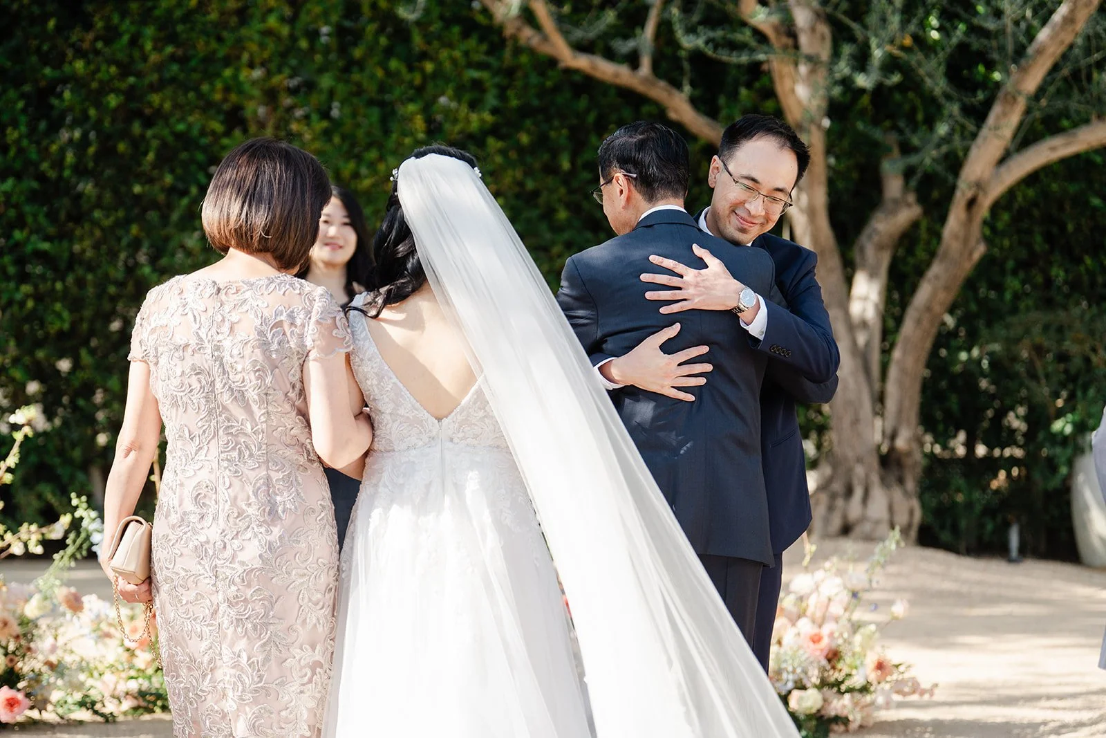 Constance's mom hugging Lawrence at the front of the aisle
