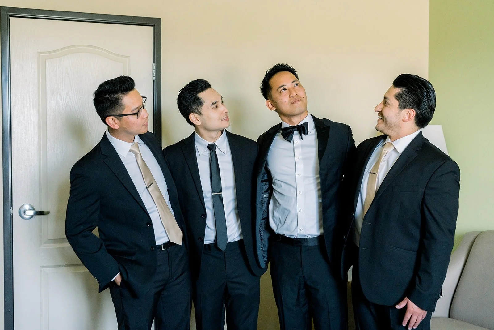 Ralph with three of his groomsmen in black tuxedos