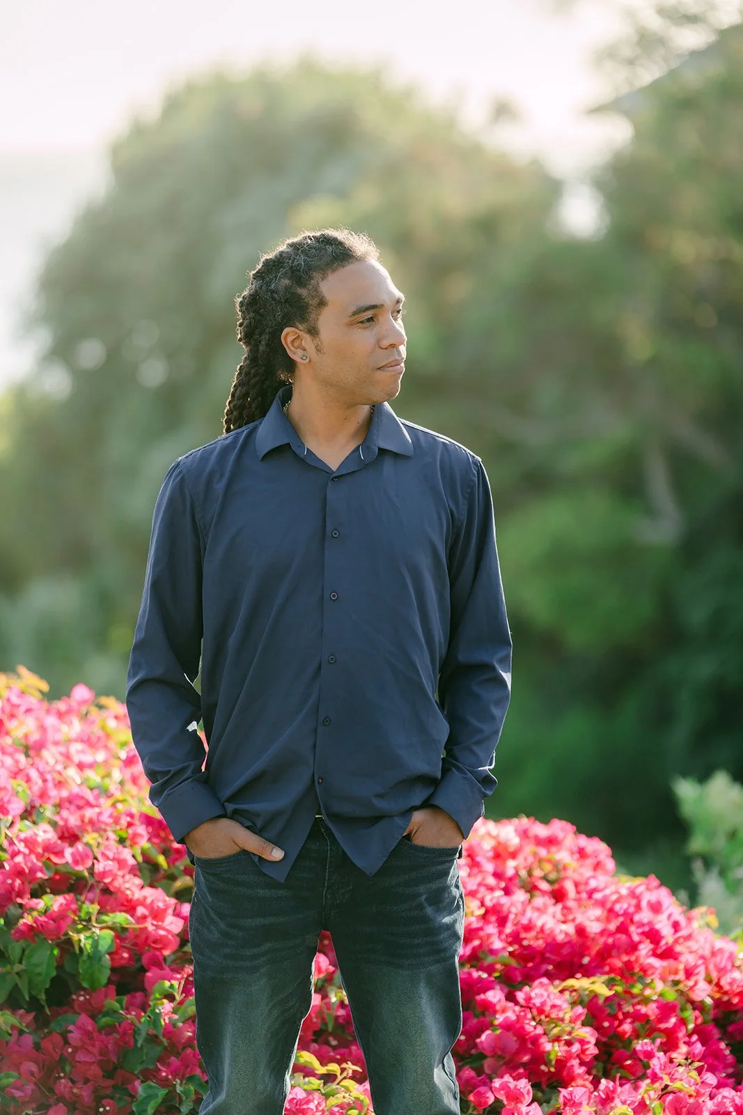 Michael in navy in front of the bougainvillea.
