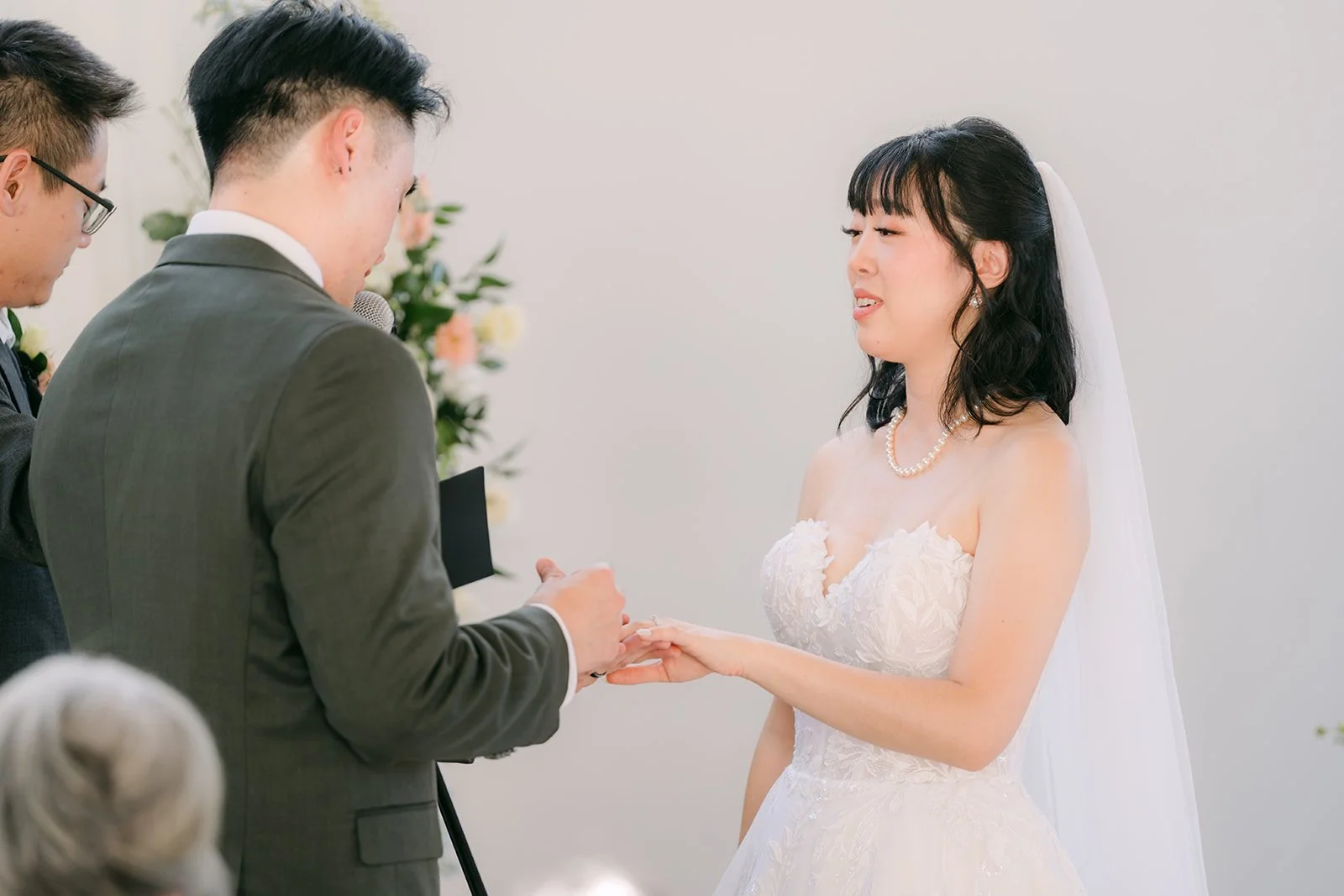 Vivian and Alex exchanging rings at their Colony House wedding ceremony