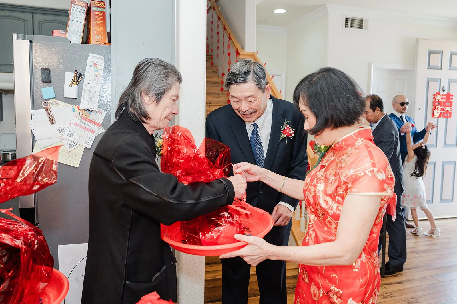 Family preparing red tea trays in the kitchen.