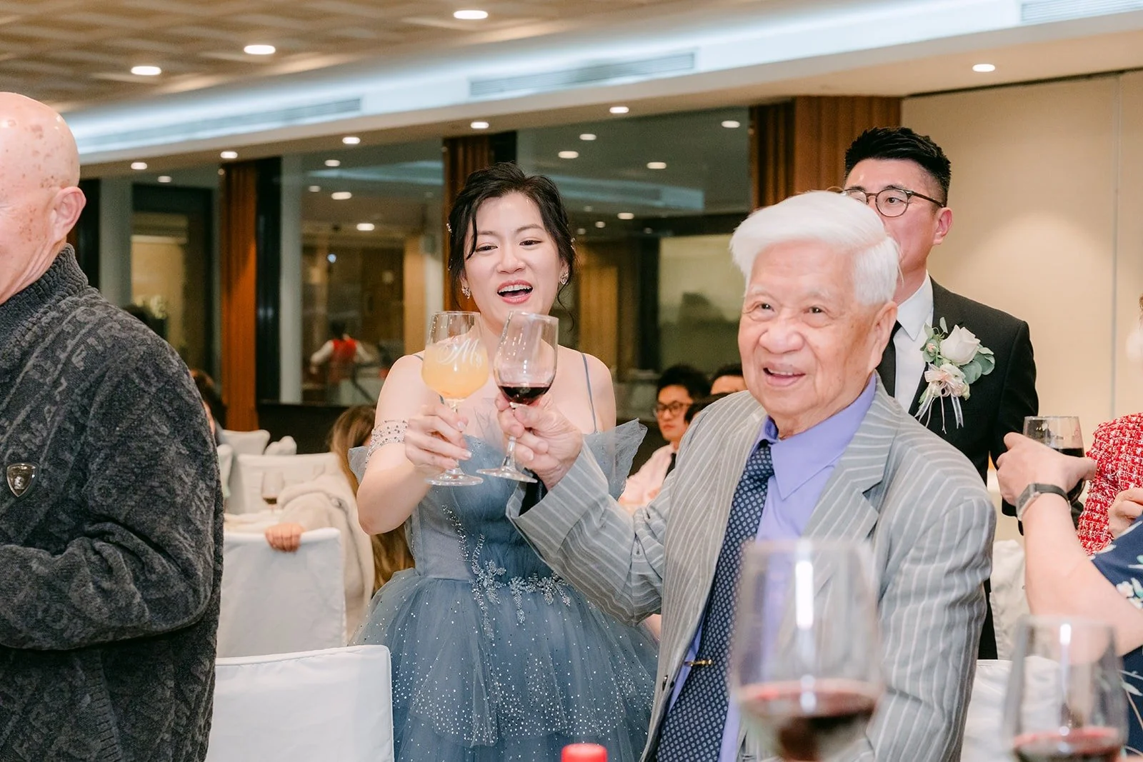 Eunice toasts with guests at their table