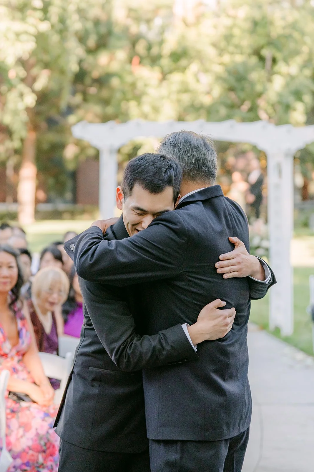 Austin hugging a guest before the ceremony