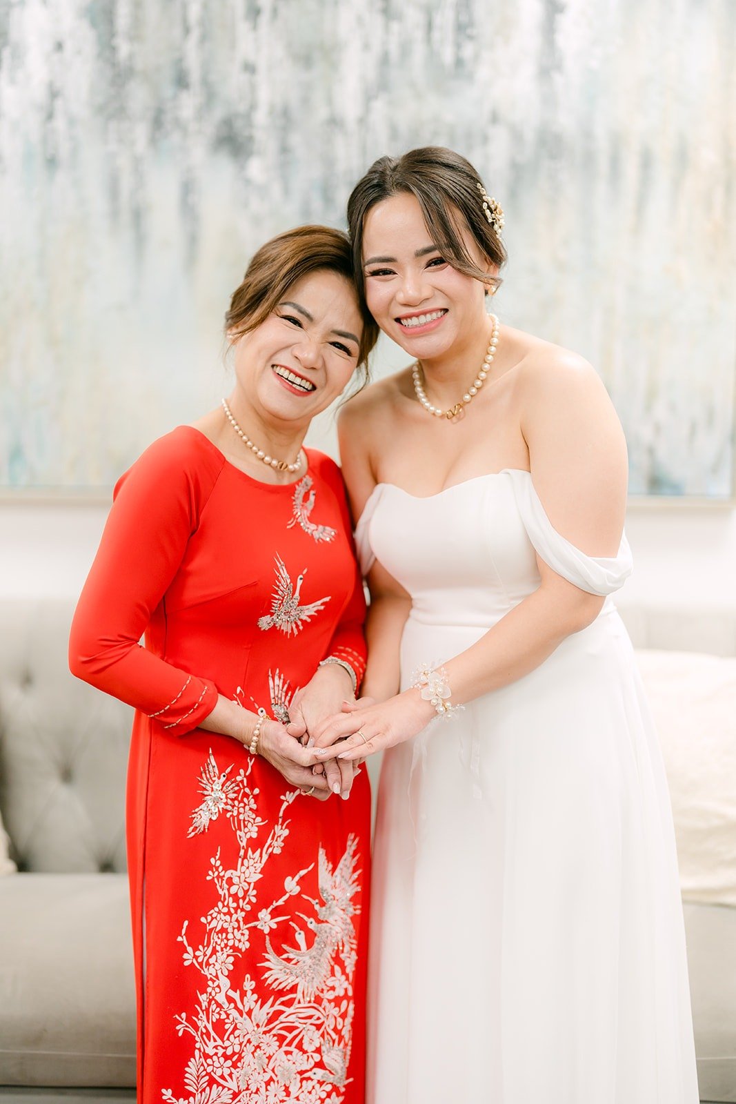Ivy holding hands with a family member in the bridal suite