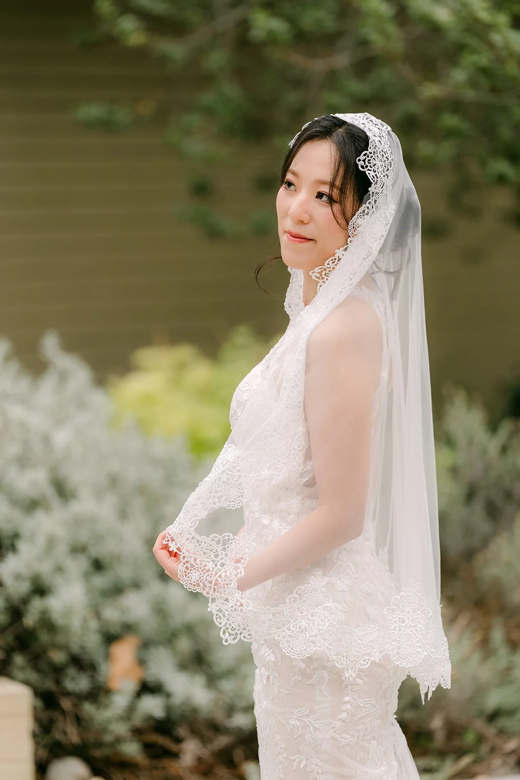 Elaine looking back over her shoulder in her veil.
