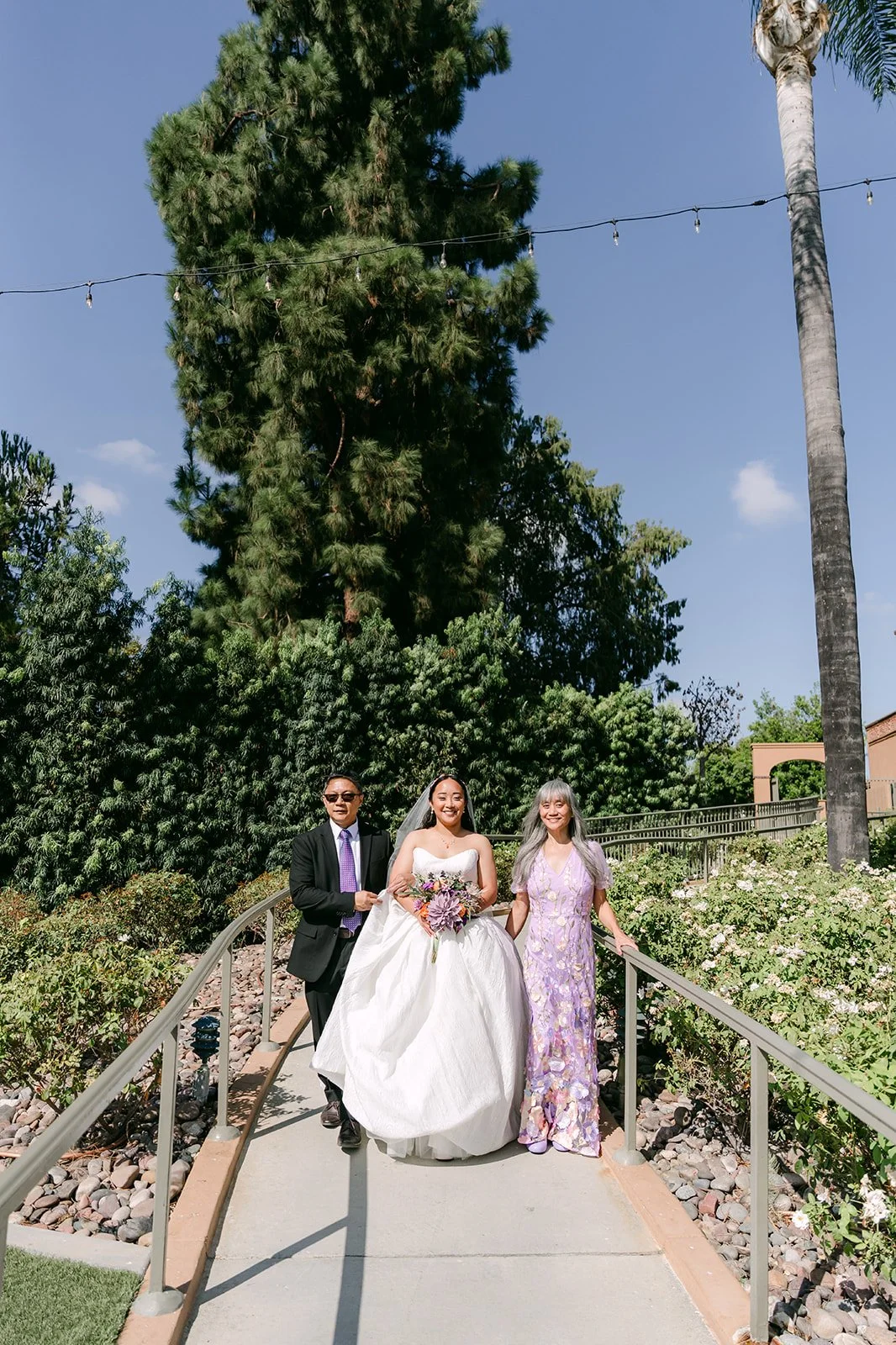 Angela walking down the garden stairs with her parents