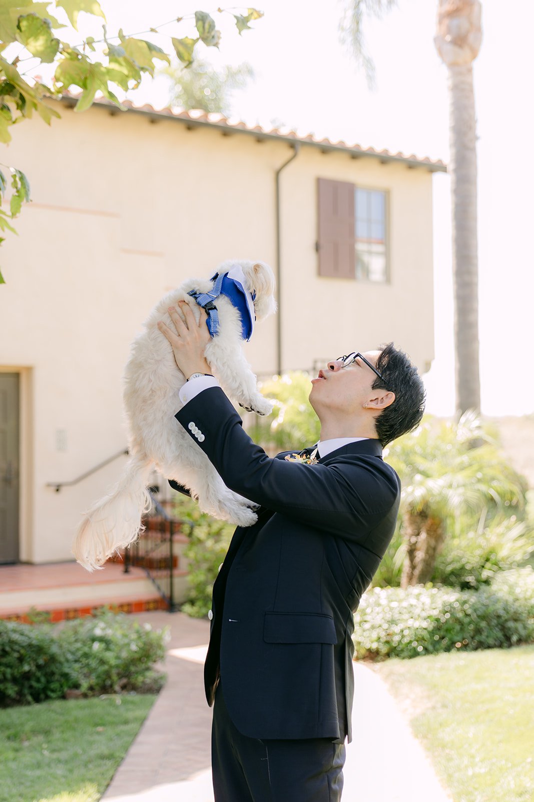 Leroy lifting the dog toward the Spanish rooftops