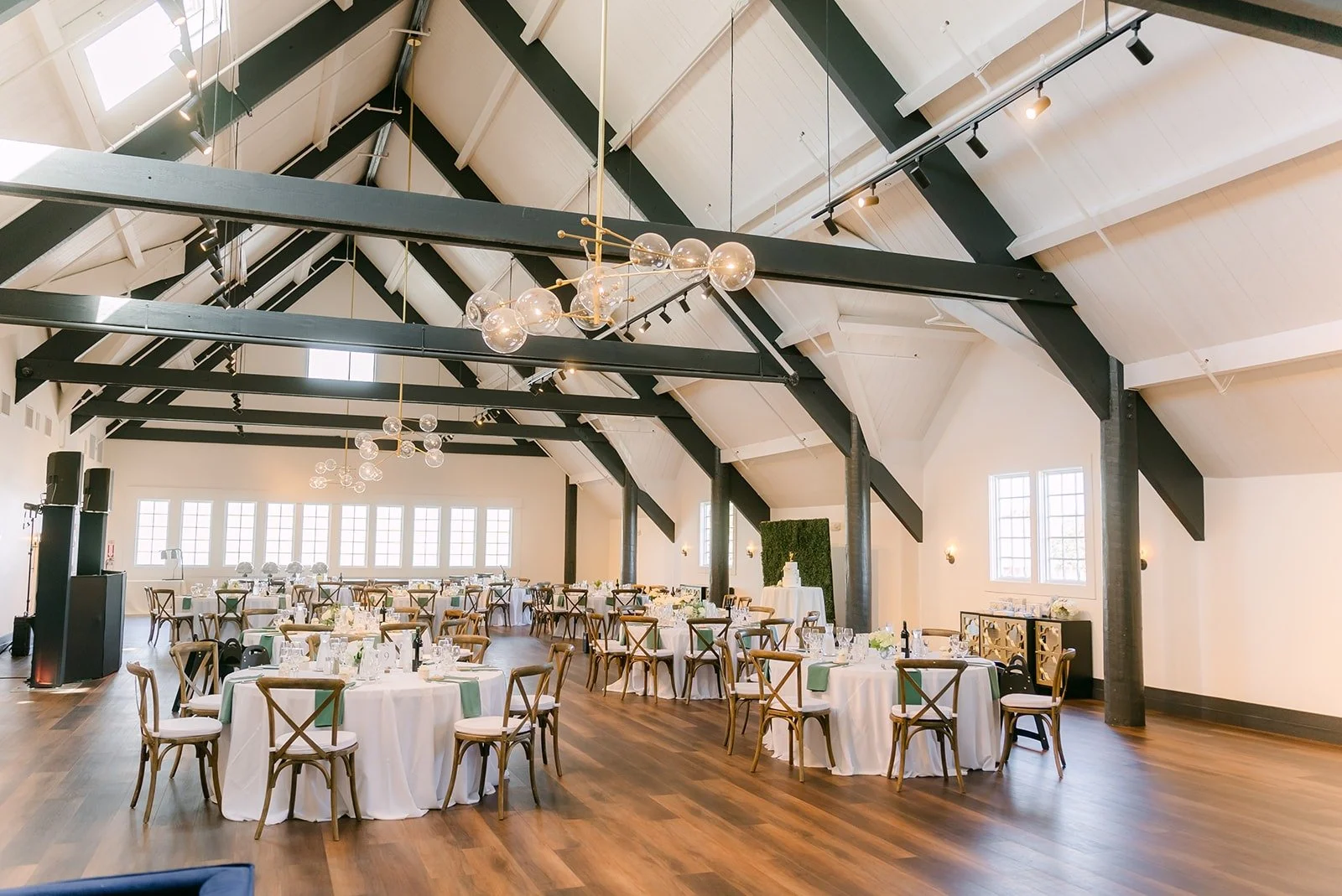 The ballroom set for the reception under exposed beams