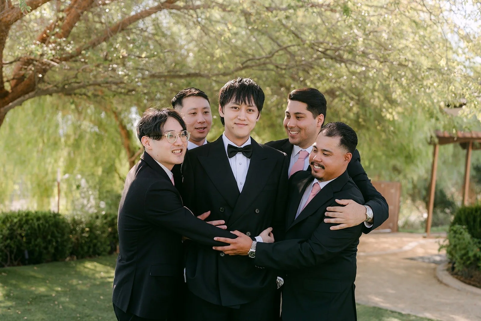 Job's groomsmen huddled around him laughing