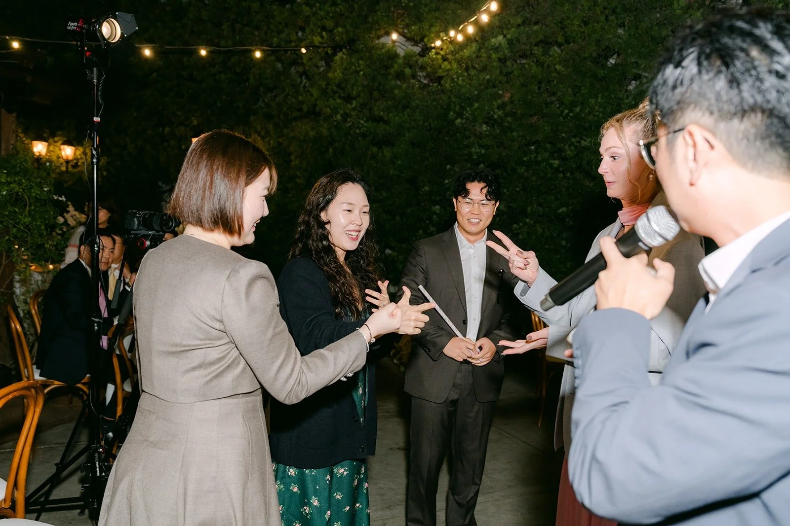 A guest on the microphone running a reception game