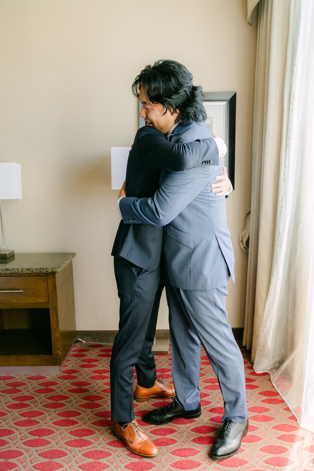 Philip sharing a hug in the hotel room