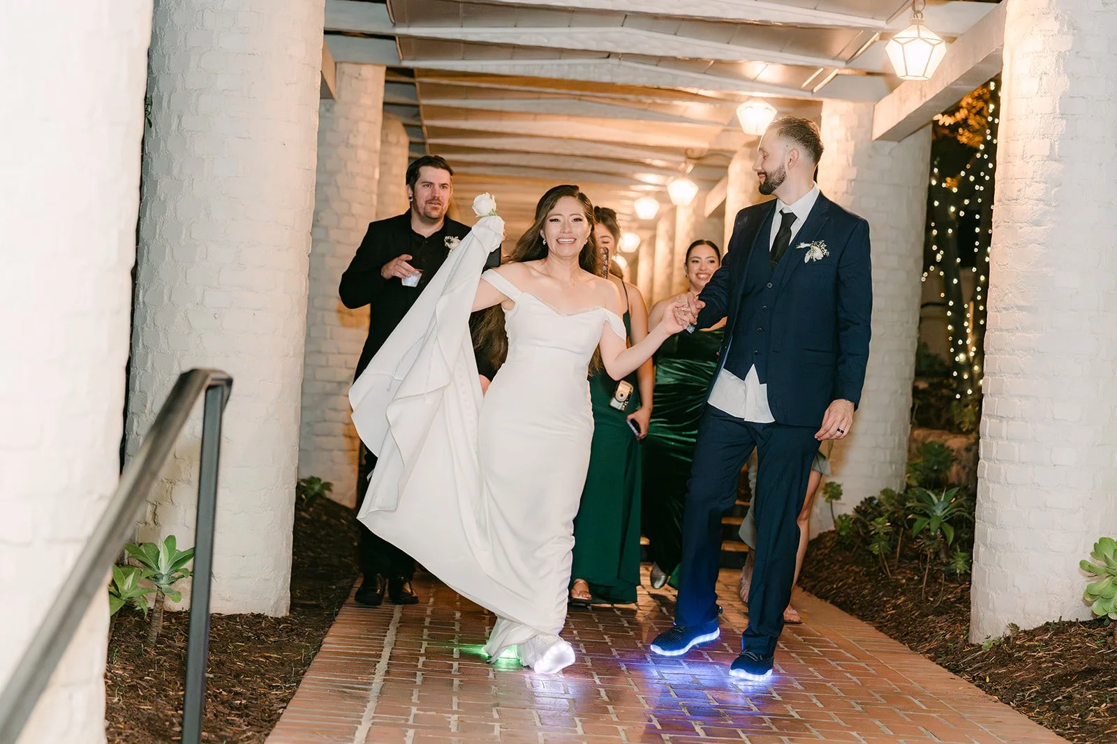 Mariana and Danny walking out under the covered entry