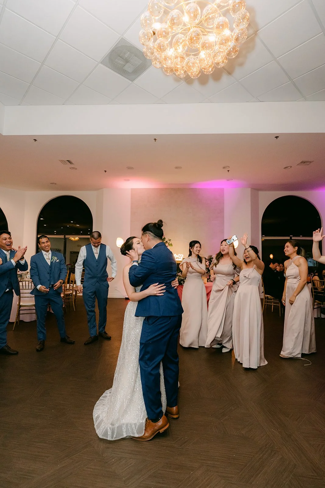Kate and Michael dancing together with guests around them.