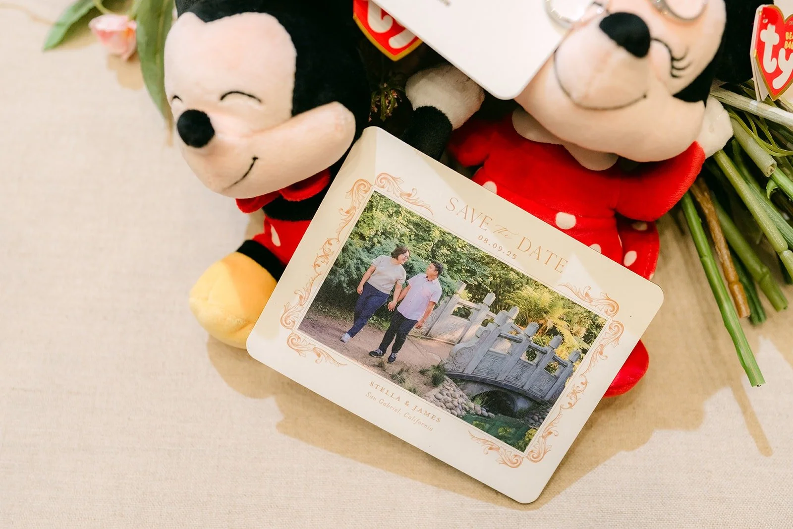 Mickey and Minnie plush toys beside a framed photo of Stella and James