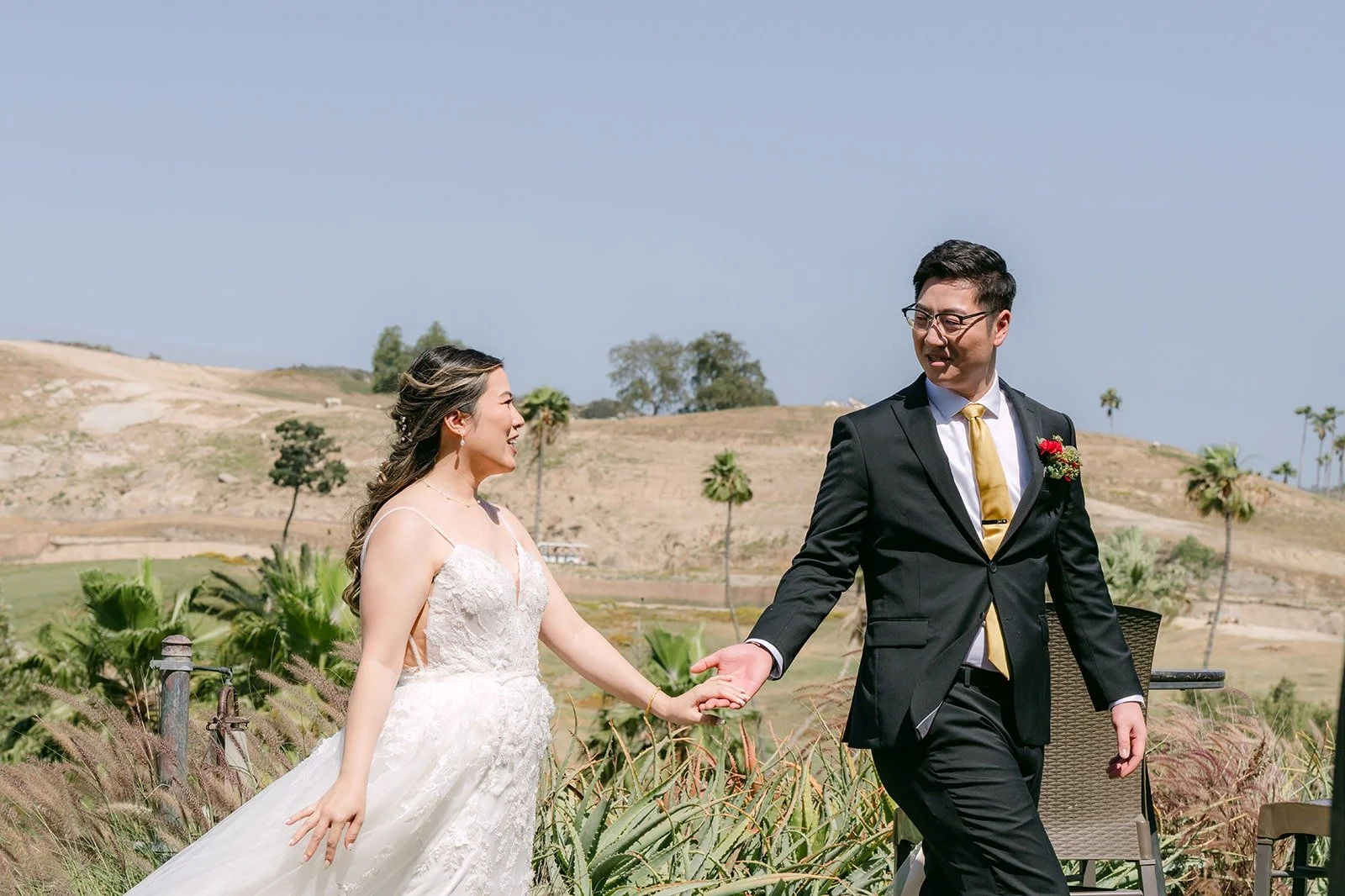 Joanne and Zach walking hand in hand on the hillside at the San Diego Zoo Safari Park